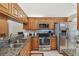 Kitchen features stainless steel appliances, granite countertops, and wooden cabinetry at 1801 E Lake Rd # 20 G, Palm Harbor, FL 34685