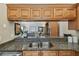 Kitchen featuring granite countertops, stainless steel appliances and view into the living room at 1801 E Lake Rd # 20 G, Palm Harbor, FL 34685