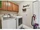 Laundry room with overhead cabinets, a washer and dryer, and a 'Laundry' themed wall decor at 1801 E Lake Rd # 20 G, Palm Harbor, FL 34685