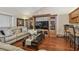 Comfortable living room featuring wood floors, a plush sofa, and a built-in entertainment center at 1801 E Lake Rd # 20 G, Palm Harbor, FL 34685