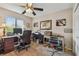 Home office featuring a ceiling fan, a window, multiple desks, a printer, and office supplies at 1801 E Lake Rd # 20 G, Palm Harbor, FL 34685