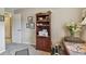 Office space with a dark wood bookshelf filled with decorative items, framed photos, and a printer at 1801 E Lake Rd # 20 G, Palm Harbor, FL 34685