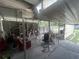 Open garage contains shelving, tools, a red recliner, and a dark colored office chair at 18133 Us Highway 41, Spring Hill, FL 34610