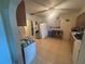 Spacious kitchen with tile flooring, white appliances, and a breakfast bar beneath the window at 18133 Us Highway 41, Spring Hill, FL 34610