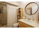 Traditional bathroom vanity with updated faucet, round mirror, and tub with shower at 1854 Lake Cypress Dr # 1854, Safety Harbor, FL 34695