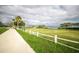 Scenic community green space features manicured lawn, sidewalk, and waterfront view, perfect for outdoor enjoyment at 1854 Lake Cypress Dr # 1854, Safety Harbor, FL 34695