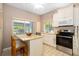 Well-lit kitchen featuring granite countertops, stainless steel appliances, and a breakfast bar at 1854 Lake Cypress Dr # 1854, Safety Harbor, FL 34695