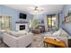 Cozy living room with light blue walls, comfortable seating, and a decorative fireplace at 1854 Lake Cypress Dr # 1854, Safety Harbor, FL 34695