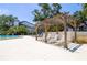 Poolside lounge chairs under a wooden pergola at 1854 Lake Cypress Dr # 1854, Safety Harbor, FL 34695