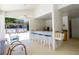 An outdoor kitchen space with barstool seating and views of the pool area at 1854 Lake Cypress Dr # 1854, Safety Harbor, FL 34695