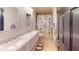 Bathroom features a double vanity with marble countertop and fun sloth-themed shower curtain at 20023 Pergola Bend Ln, Tampa, FL 33647