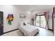 Bright bedroom with a slider door leading to a balcony and pink decorations at 20023 Pergola Bend Ln, Tampa, FL 33647