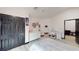 room featuring light pink walls, modern decorations, a work desk, and laminate wood flooring at 20023 Pergola Bend Ln, Tampa, FL 33647