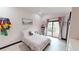 Bedroom with a slider door leading to a balcony and pink decorations at 20023 Pergola Bend Ln, Tampa, FL 33647