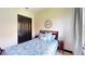 Cozy bedroom featuring a clock on the wall, a wooden bed, and matching nightstands at 20023 Pergola Bend Ln, Tampa, FL 33647