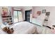 Bright bedroom with a sliding glass door, a closet, and a bookshelf filled with books at 20023 Pergola Bend Ln, Tampa, FL 33647