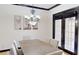 Dining room featuring a modern chandelier, neutral decor, and double doors to the outside at 20023 Pergola Bend Ln, Tampa, FL 33647