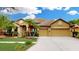 Charming single-story home with a tile roof, lush landscaping, and a spacious three-car garage at 20023 Pergola Bend Ln, Tampa, FL 33647