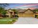 Charming single-story home with a tile roof, lush landscaping, and a spacious three-car garage at 20023 Pergola Bend Ln, Tampa, FL 33647