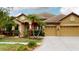 Charming single-story home with a tile roof, well-manicured landscaping, and a three-car garage at 20023 Pergola Bend Ln, Tampa, FL 33647