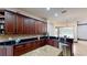 Gourmet kitchen with granite countertops, stainless steel appliances, and dark wood cabinets at 20023 Pergola Bend Ln, Tampa, FL 33647
