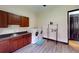 Bright laundry room with modern washer, dryer, and beautiful wood cabinetry at 20023 Pergola Bend Ln, Tampa, FL 33647