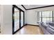 Bright room with french doors and large window for natural light adjacent to the cozy living room at 20023 Pergola Bend Ln, Tampa, FL 33647