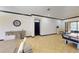 Open living space featuring tile flooring, with a piano, game table, and plenty of light at 20023 Pergola Bend Ln, Tampa, FL 33647