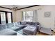 This comfortable living room boasts a view to the backyard and a stylish gray sectional sofa at 20023 Pergola Bend Ln, Tampa, FL 33647