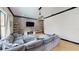 Comfortable living room with an oversized sectional sofa and a wall mounted TV above a modern fireplace at 20023 Pergola Bend Ln, Tampa, FL 33647