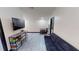 Spacious living room with sleek flooring, a comfortable couch, and a large entertainment center with a TV at 20023 Pergola Bend Ln, Tampa, FL 33647