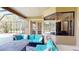 Cozy screened-in lanai featuring comfortable seating, a fire pit table, and views of the pool at 20023 Pergola Bend Ln, Tampa, FL 33647