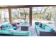 Inviting outdoor living space with modern furniture, a pool, and a spa under screened enclosure at 20023 Pergola Bend Ln, Tampa, FL 33647