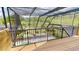 Screened porch overlooking backyard pool area with mature trees and greenery at 20023 Pergola Bend Ln, Tampa, FL 33647