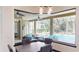 The Dining room view captures the beauty of the outdoor lanai and sparkling pool at 20023 Pergola Bend Ln, Tampa, FL 33647