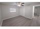 Neutral bedroom with ceiling fan, large window, and closet with sliding doors at 2045 Summit Dr, Dunedin, FL 34698