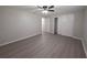 Neutral bedroom with ceiling fan, updated flooring, and closet with sliding doors at 2045 Summit Dr, Dunedin, FL 34698