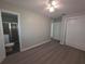 This is a bedroom with an en-suite bathroom featuring wood-look flooring and a ceiling fan at 2045 Summit Dr, Dunedin, FL 34698