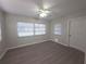 Light-filled bedroom with modern floors and a ceiling fan at 2045 Summit Dr, Dunedin, FL 34698