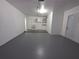 Bright and spacious garage featuring updated flooring and separate access door at 2045 Summit Dr, Dunedin, FL 34698