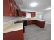 Well-lit kitchen with wood cabinets, black appliances, and light countertops at 2045 Summit Dr, Dunedin, FL 34698