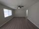 Airy living room with ceiling fan, modern floors, and a large window at 2045 Summit Dr, Dunedin, FL 34698