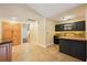 A small bar area with dark cabinets, a wood countertop, and tile backsplash at 25238 Bunting Cir, Land O Lakes, FL 34639