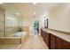 Elegant bathroom featuring a glass-enclosed shower, soaking tub, and dual sink vanity at 25238 Bunting Cir, Land O Lakes, FL 34639