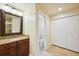 Bathroom features a single vanity with a warm granite countertop and a separate toilet room at 25238 Bunting Cir, Land O Lakes, FL 34639