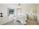 Well-lit bedroom featuring white furniture and a view of the outdoors through a large window at 25238 Bunting Cir, Land O Lakes, FL 34639