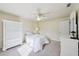 Bedroom showcasing white furnishings, ceiling fan, and ample natural light at 25238 Bunting Cir, Land O Lakes, FL 34639