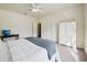 Bright bedroom with a ceiling fan, a bed, and a large white armoire offering ample storage space at 25238 Bunting Cir, Land O Lakes, FL 34639