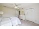Bright bedroom featuring a ceiling fan, double door closet, a dresser with a mirror, and natural light at 25238 Bunting Cir, Land O Lakes, FL 34639