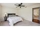 Cozy bedroom with a decorative lamp on a table and bed with decorative pillows; great natural light at 25238 Bunting Cir, Land O Lakes, FL 34639